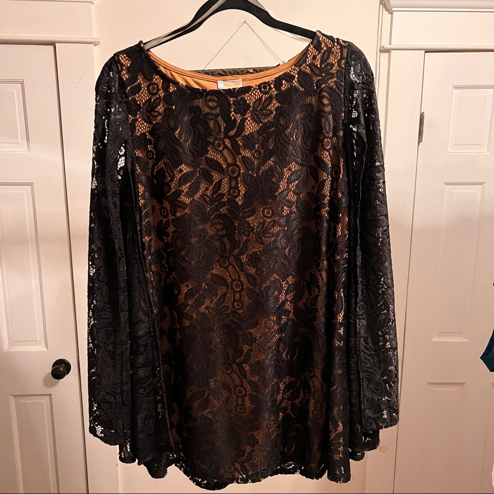 60’s style shift dress with black lace sleeved wings, nude underdress.